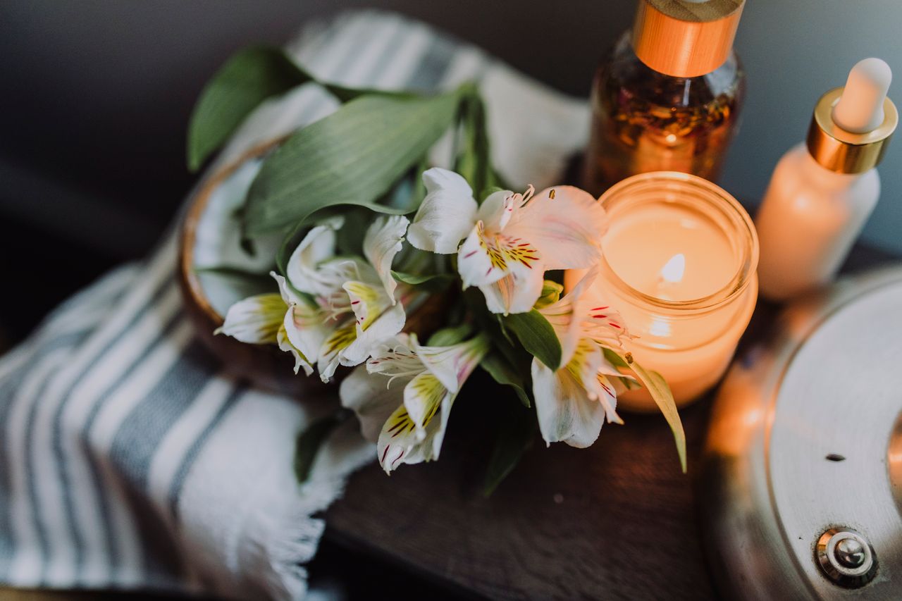 Ambient scene with candle, flowers, and decorative elements for a cozy setting.